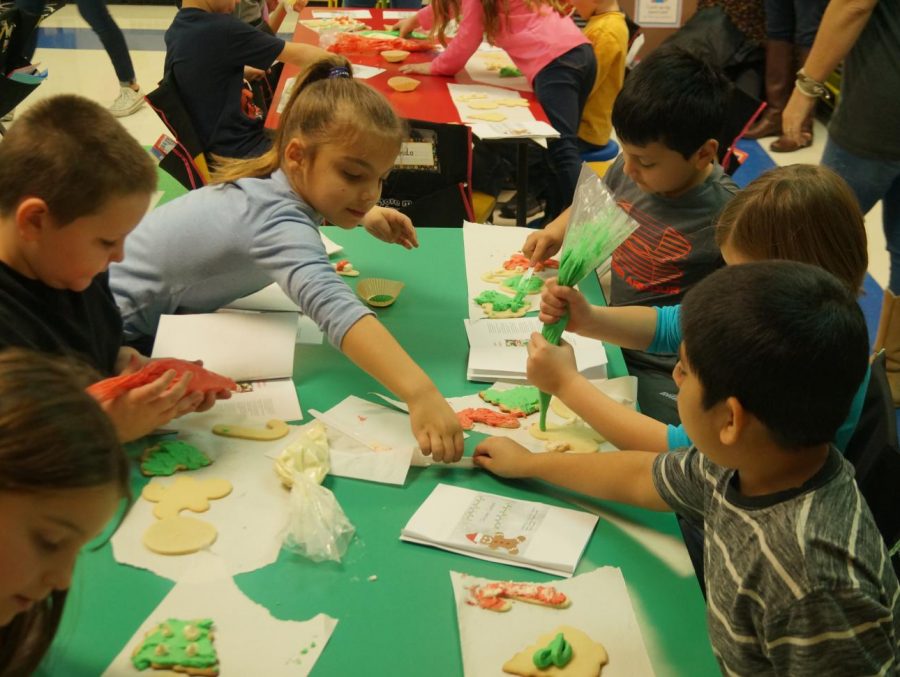Chester Grade School students make Christmas cookies under the direction of CHS Culinary Arts students.