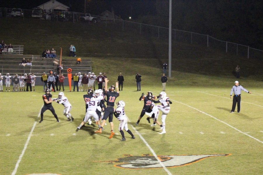 Ian Reith [12) and Caleb Parker [39) attempt to block a Carmi punt.