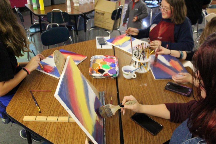 Students paint during Art Club.