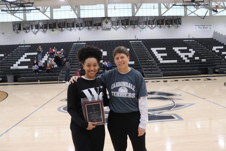 Destiny+Williams+received+the+Carbondale+Mid-Winter+Classic+MVP+award+from+Carbondale+Assistant+Athletic+Director+Marialice+Jenkins.