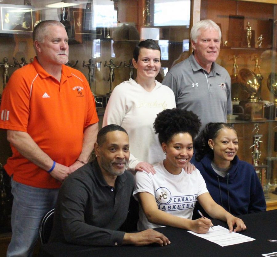 Destiny+Williams+front+row%2C+center%29+signs+her+letter+of+intent+to+play+basketball+at+Johnson+County+Community+College+in+Overland+Park%2C+Kans.+She+is+flanked+by+parents+Ron+and+Amy+Williams.+In+the+back+are+Chester+coaches+Rick+Powley%2C+Jennifer+King+and+Pat+Knowles.