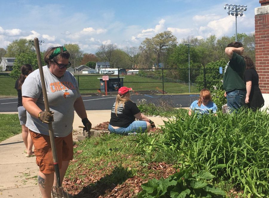 Members of the Environmental Club did some weeding in front of the school.