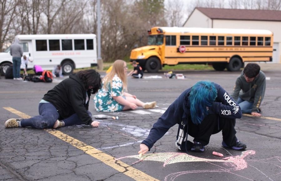 Mikayla Straight, Chelsea August Kerringtyn Malley and Cesar Marquez work on their design at the Chalk Walk.