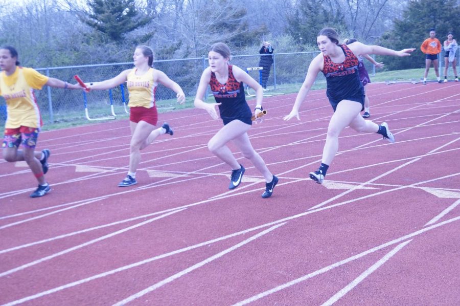 Gianna+Eggemeyer+takes+the+hand-off+from+Paige+Vasquez+during+a+relay+March+29.