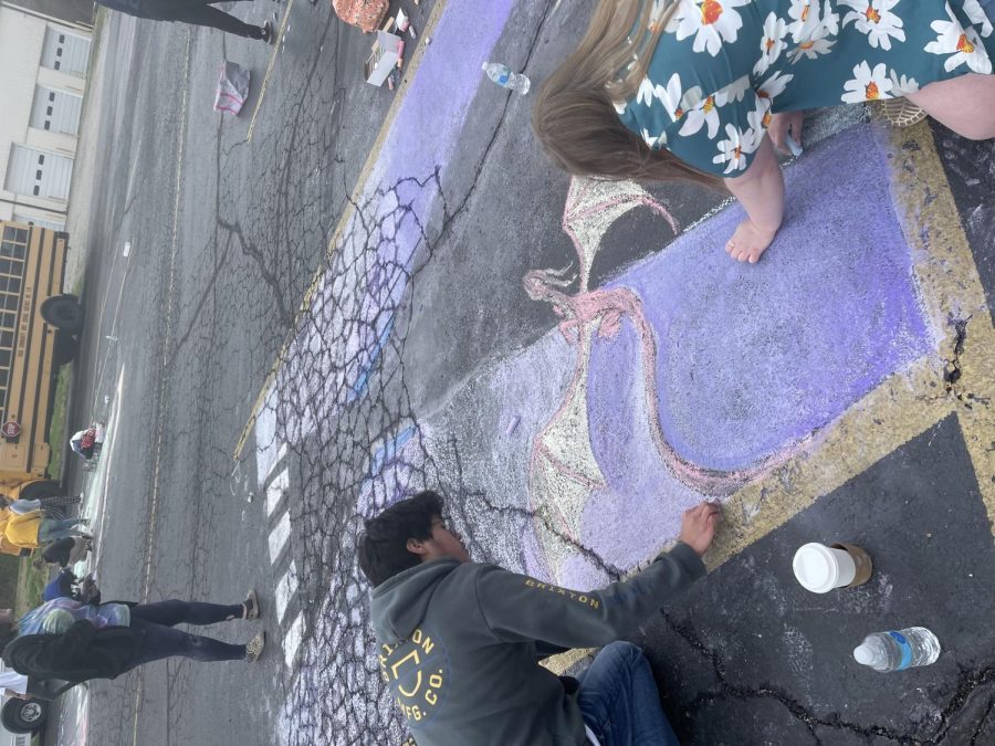 Cesar Marquez and Chelsea August work on a design at the Chalk Walk.