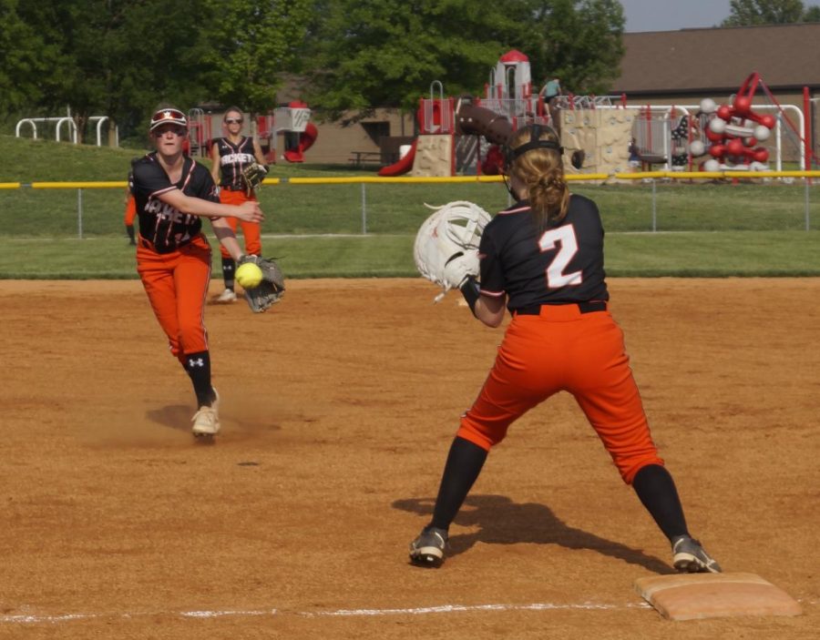 Kinsli McCartney throws out a Sparta batter to Anna Childs.