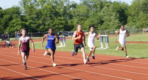 Aiden Jany (center) won the 400 and took second in the 100 to qualify for state in both events.
