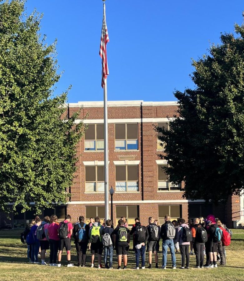 The Fellowship of Christian Athletes gathers at the flagpole to observe the National Day of Prayer.