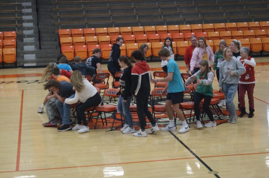Students+and+teachers+competed+in+a+game+of+musical+chairs+during+the+Christmas+assembly.