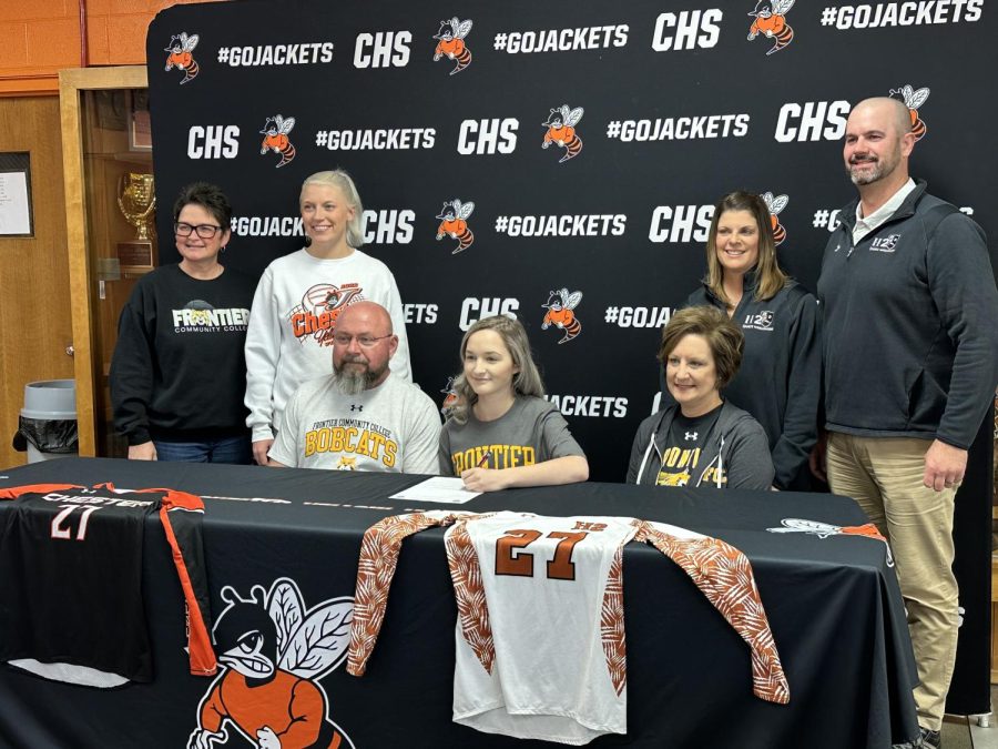 Paige Thomas signed a letter of intent to play volleyball at Frontier Community College in Fairfield. She is surrounded by her parents and coaches.