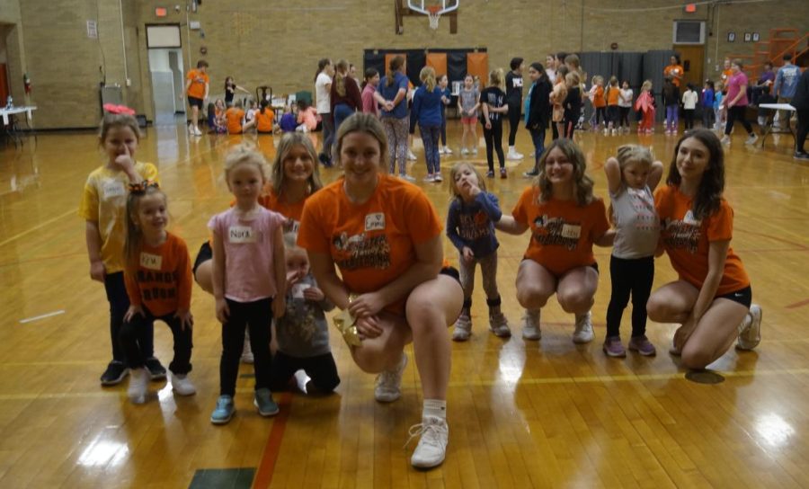 Ellen McCormick, Emma Eggemeyer, Libby McCormick and Peyton Cole are pictured with their little cheerleaders.