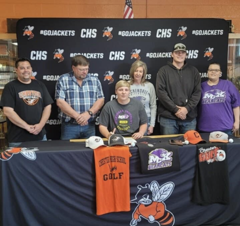 Surrounded by family and coaches, Clayton Andrews signed a letter of intent to play golf at McKendree University.