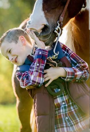 Jack Kennedy, age 7, spending time with his horse. 