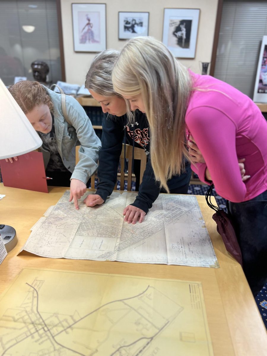 Morris Library - Special Collections 
Bailey Sellers, Camryn Luthy, and Katelin Conway point out locations on a very old map of Randolph County