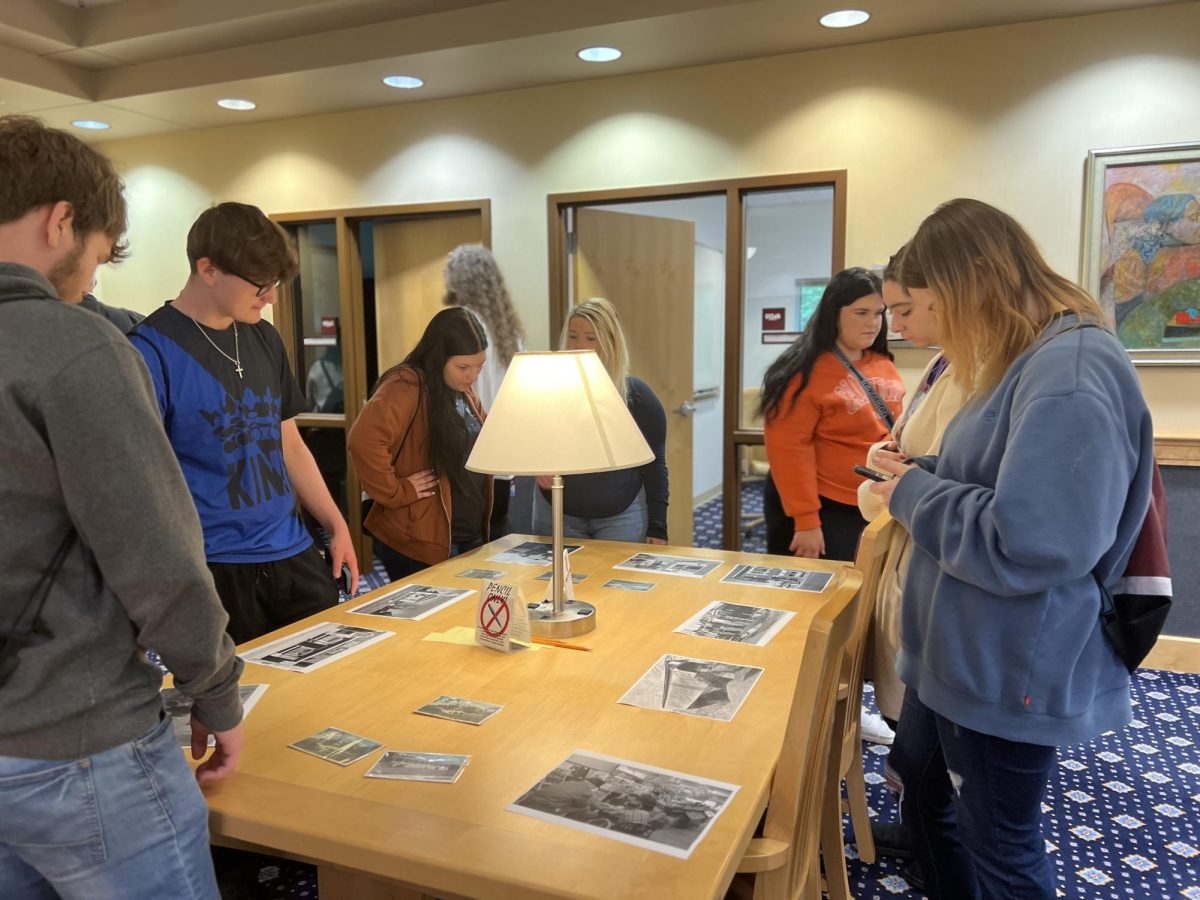 Morris Library - Special Collections 
Students Blake Farmer, Gavin Thompson, Alyssa McCormick, Eva Meade, Cheslli Cumberland and Brooklyn Webb learn about Chester history with photos from 1971 