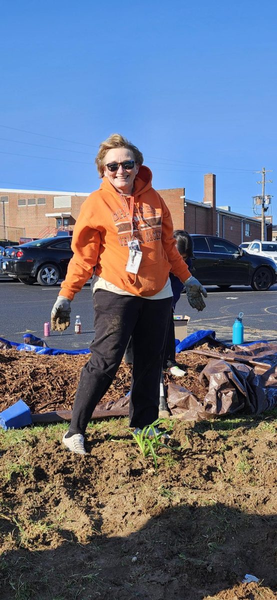 Mrs. Boyd helping plant trees and day lillies