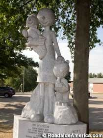 Olive Oyl's statue who is accompanied by Swee'Pea and Jeep. The statue is located near the Chester Court House.