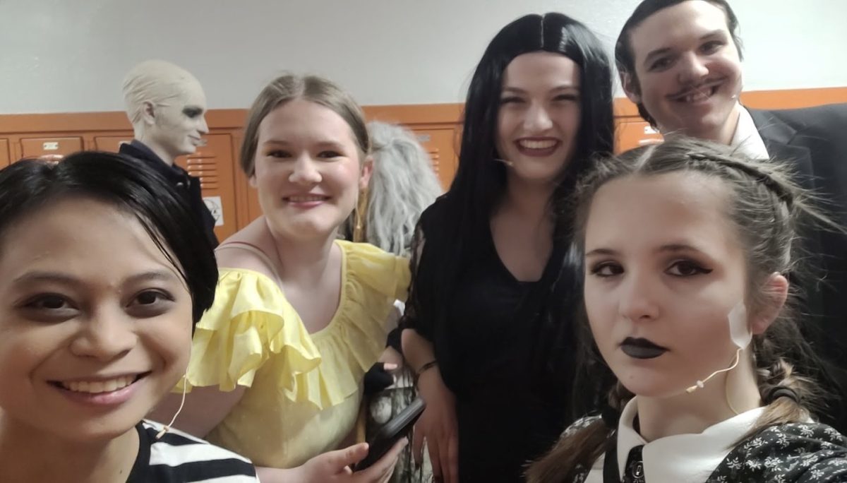 Cast members Nico Deguzman, Megan Zimmer, Grace Kirkpatrick, Ary Shipley, and Jason Sibley taking an in-costume photo.