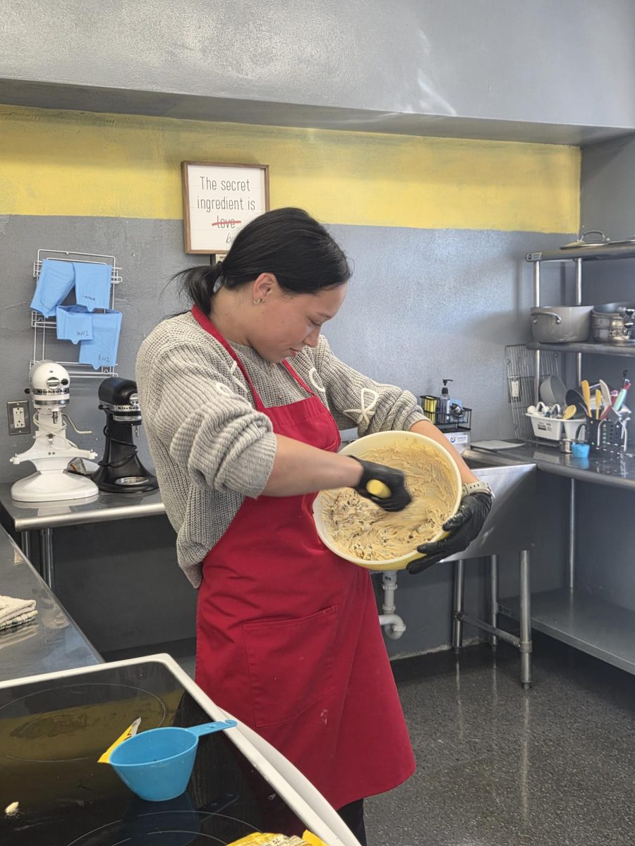 Tasia Foulks stirring chocolate chip cookie dough 