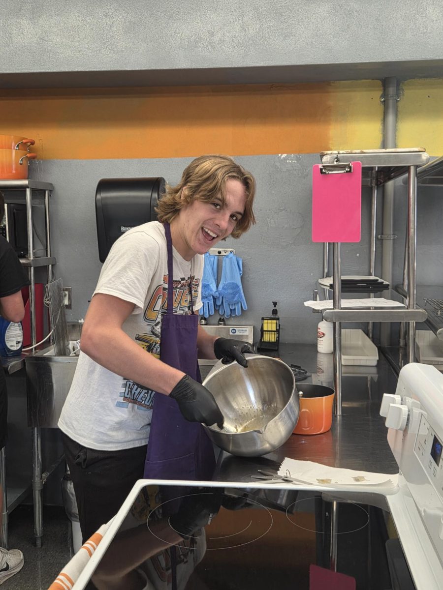 Zane Eggemeyer beating eggs for his cookie dough