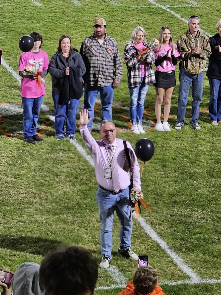 Mr. Colonel being recognized for his final football game with band.