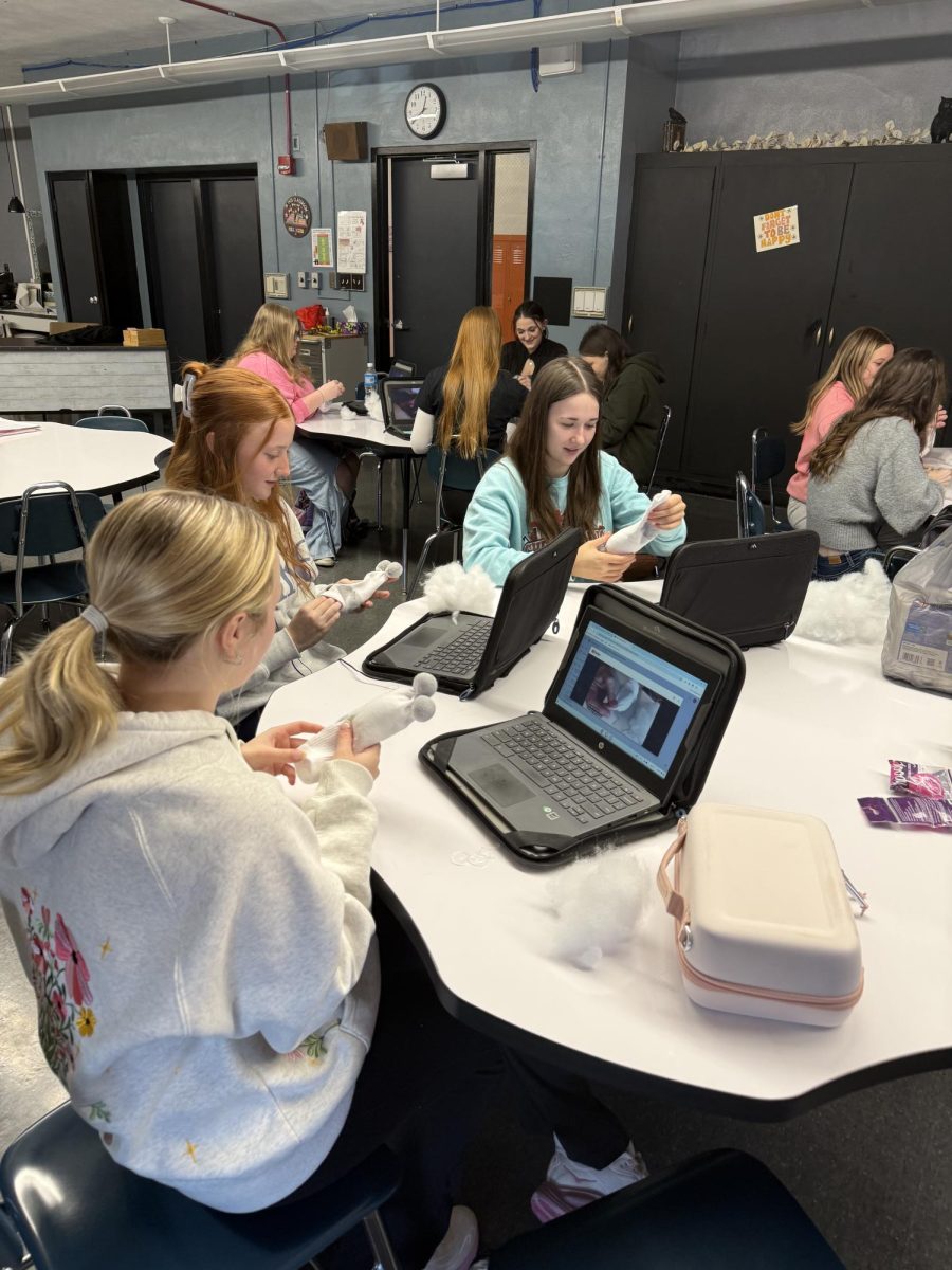 Student working on their sock babies.
