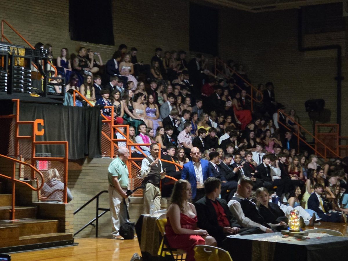 Student, family and friends watching the coronation ceremony